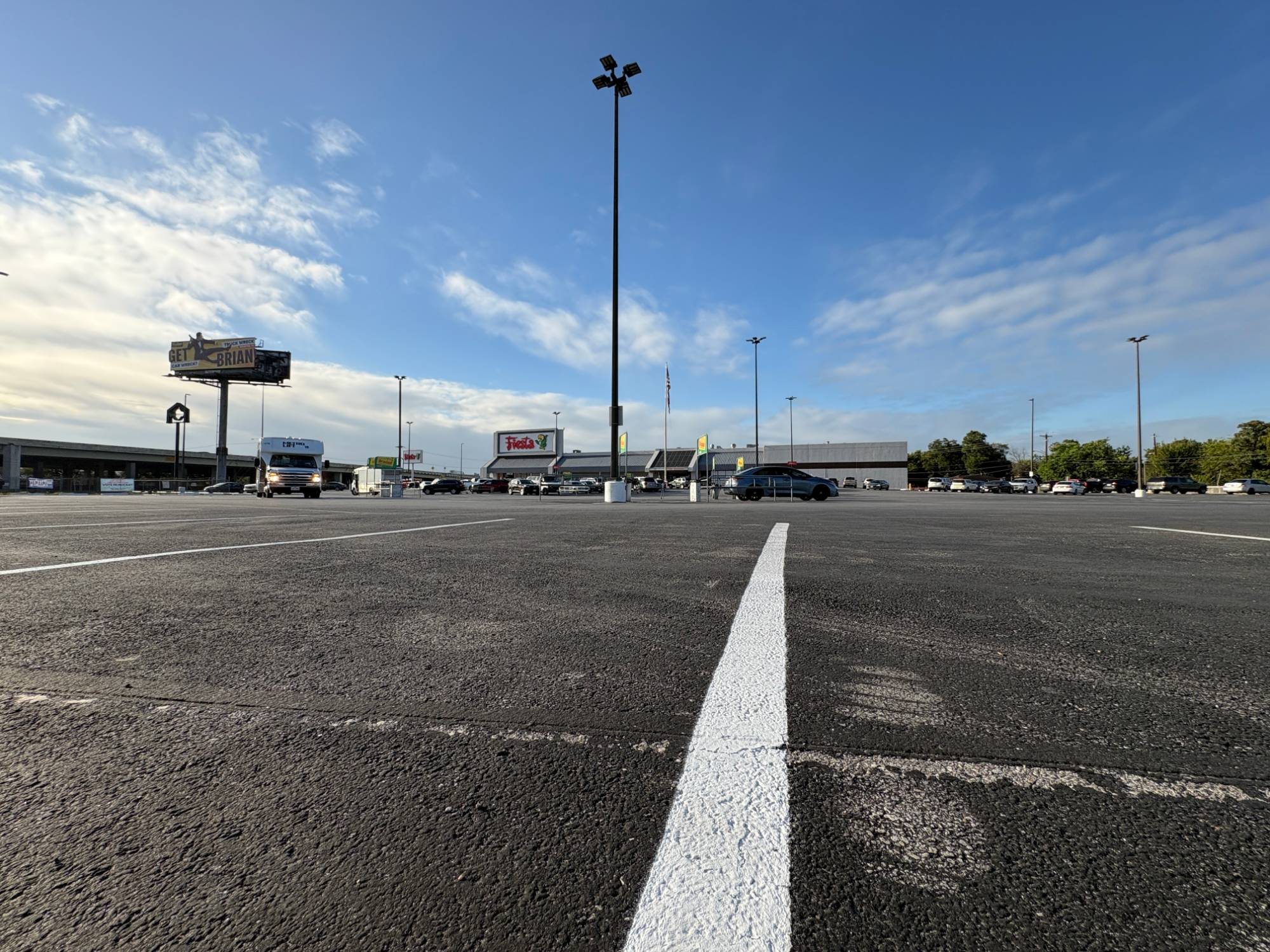 The grocery store parking lot in north Houston where we met Scott, nearly empty under a blue sky.